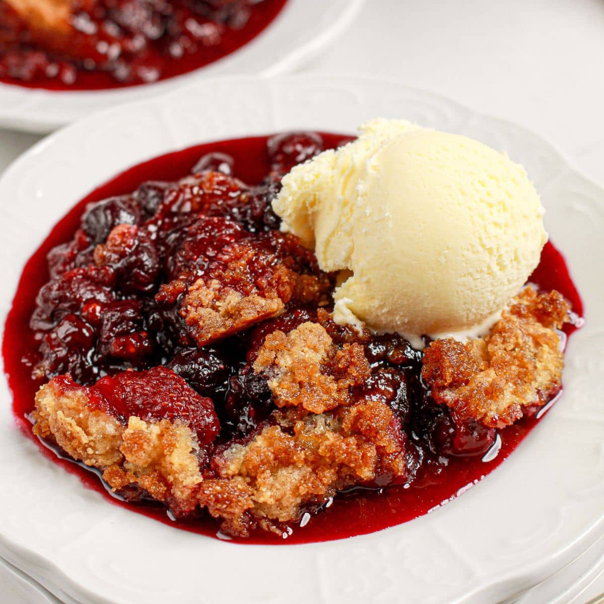 Mixed berry cobbler on a small plate.
