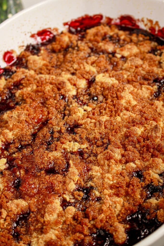 Baked cobbler in a white baking dish.