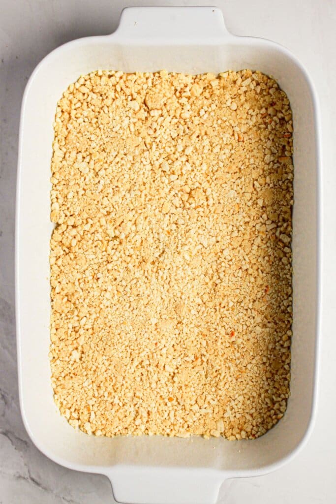 Crust being pressed into a baking dish.