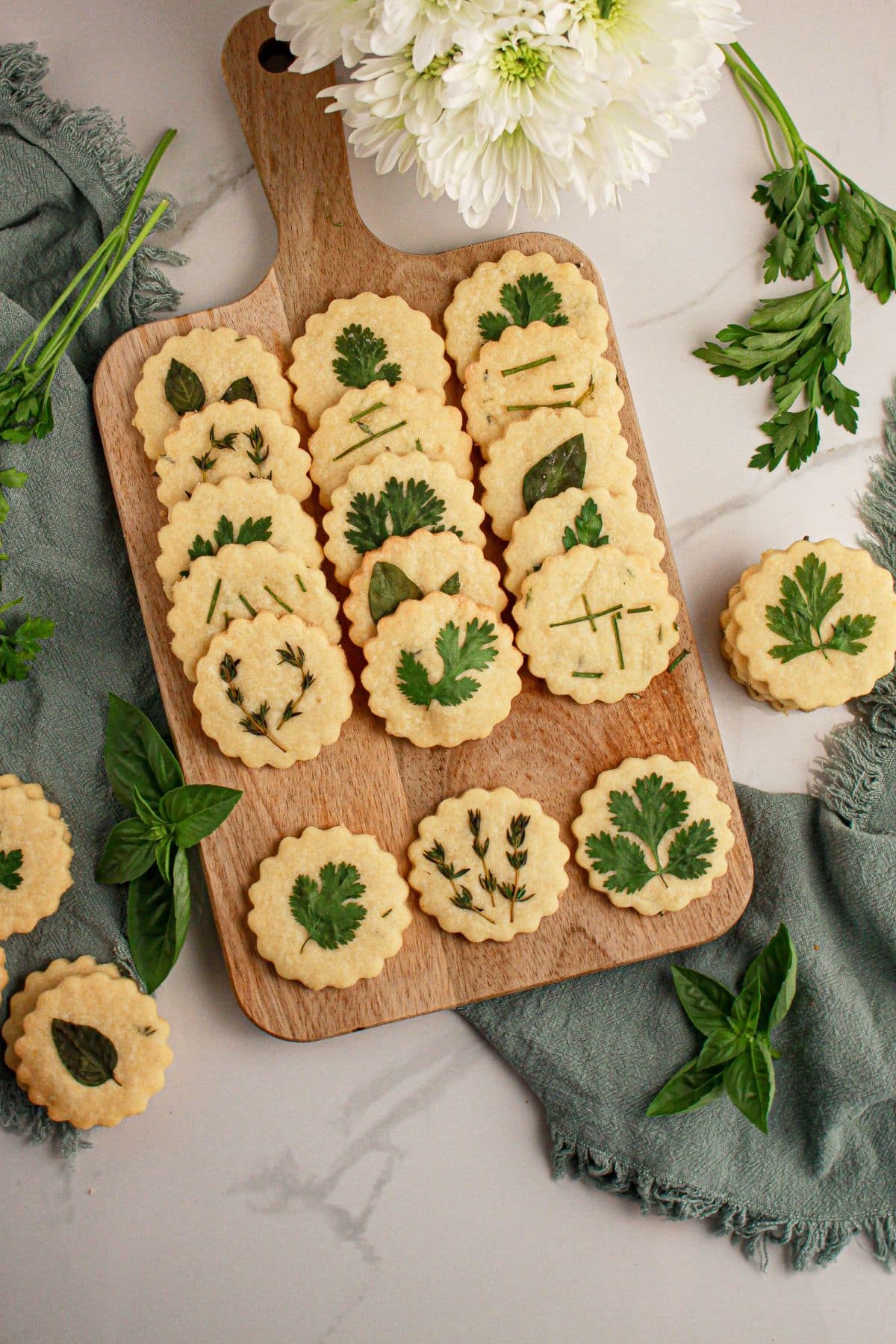 Cutting board full of parmesan cookies.