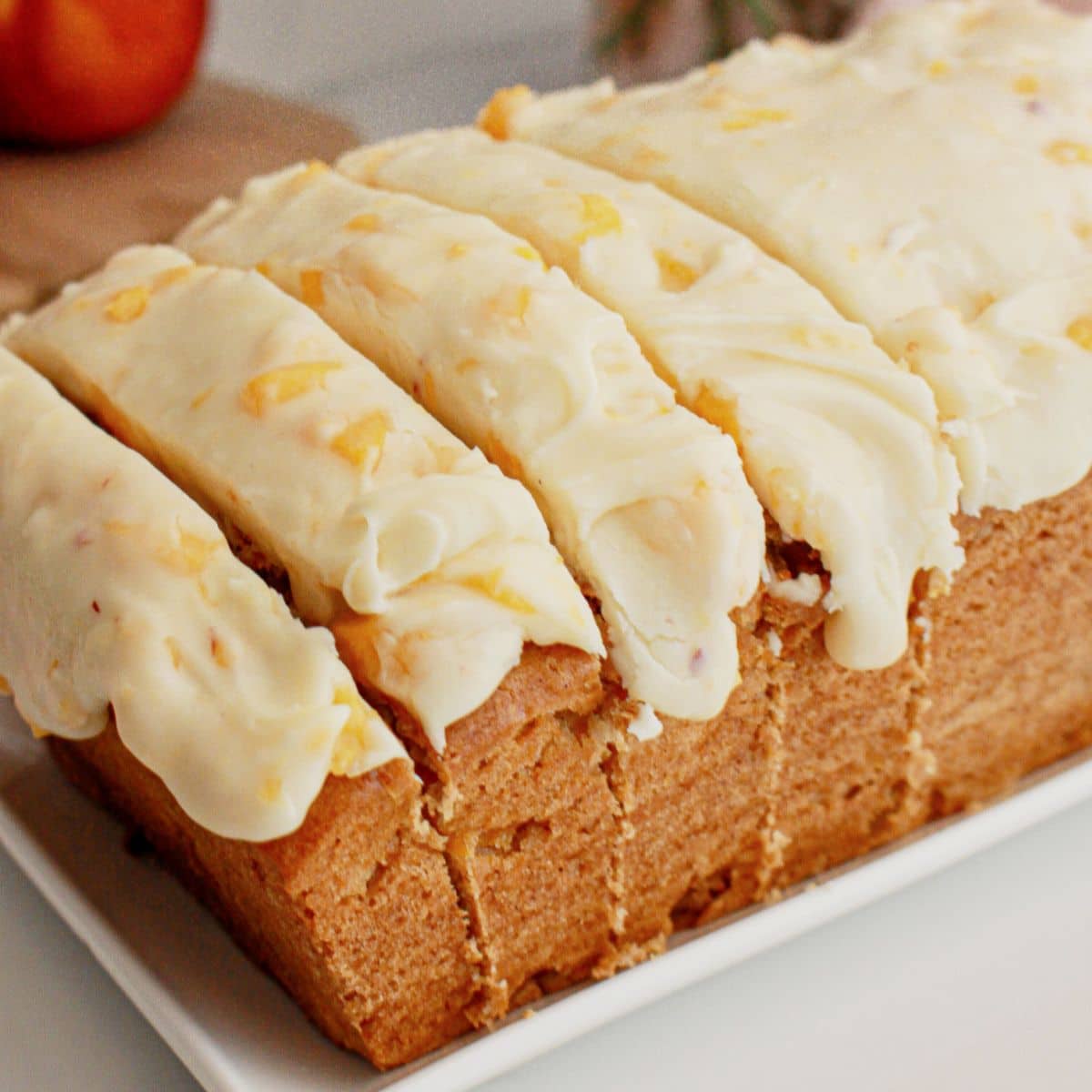 Peach bread slices on a square plate.