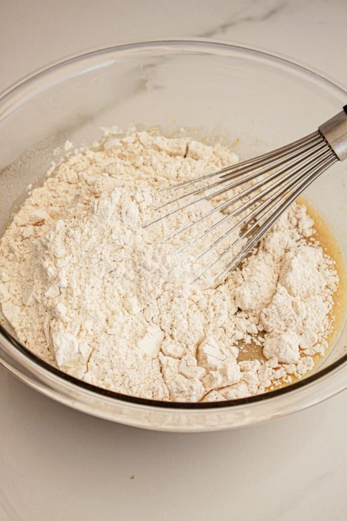 Dry ingredients being added to the wet ingredients.