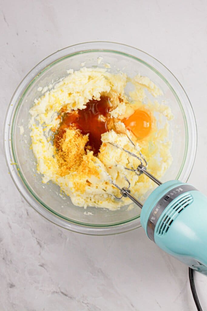 Eggs and vanilla being mixed into dough.