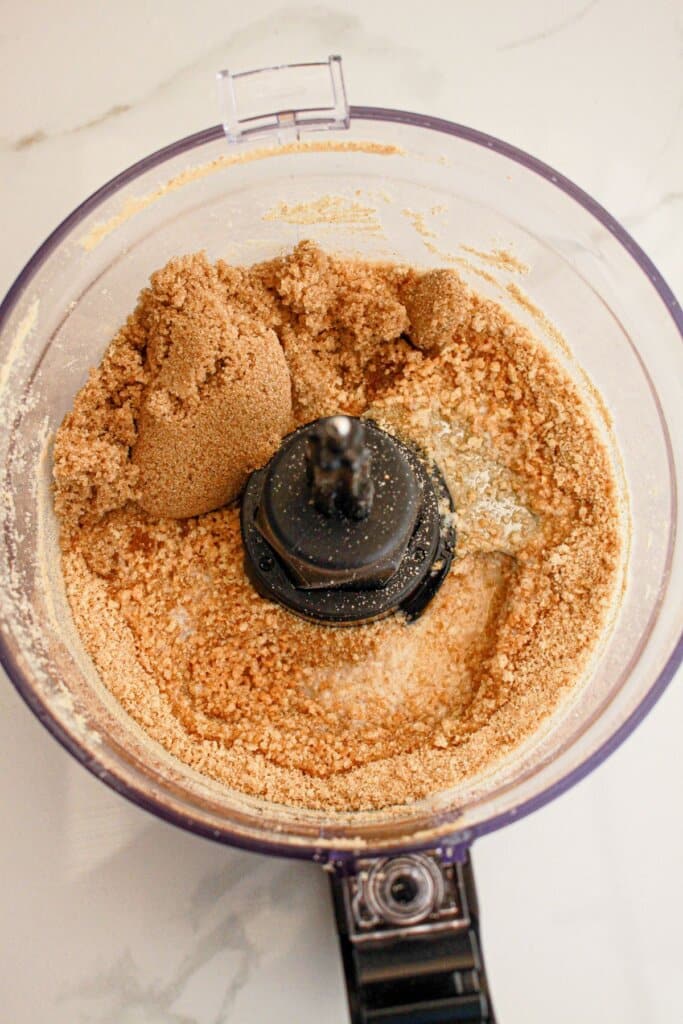 Graham crackers being crushed in a food processor.