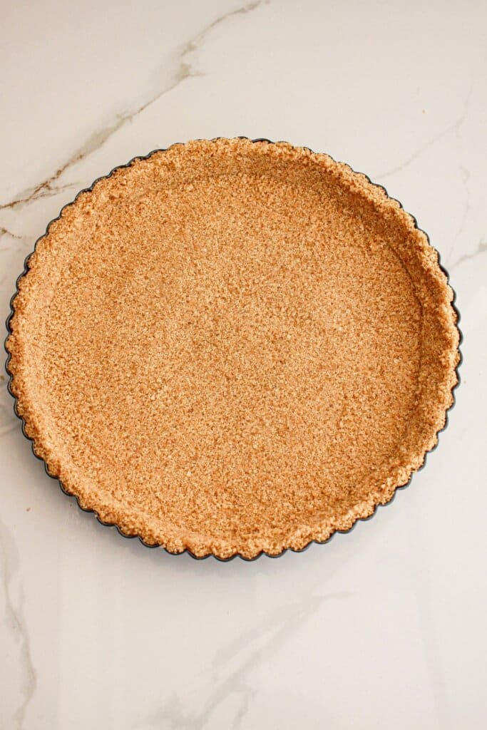 Graham cracker crust in a tart pan.