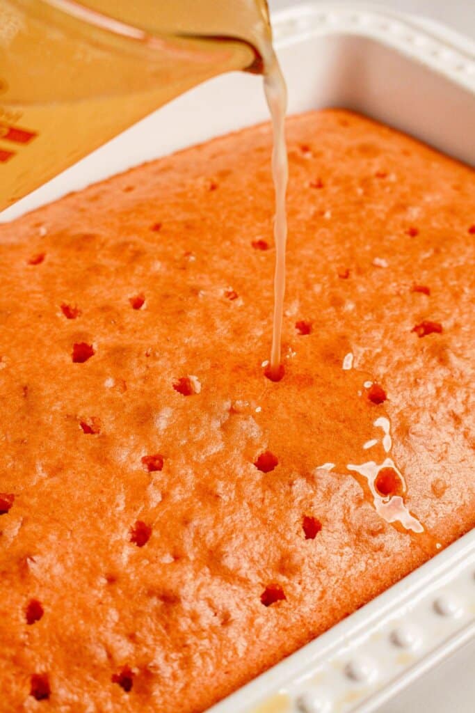 Lemonade being poured on top of cake.
