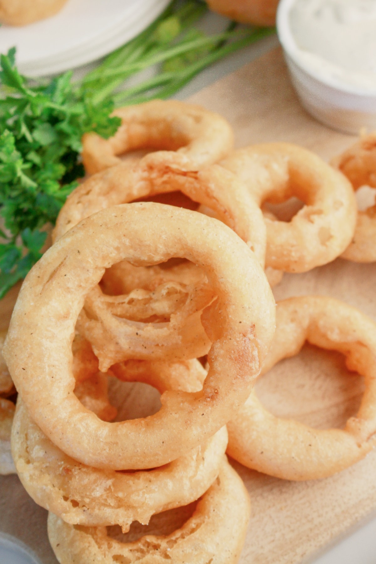 Onion rings on a wooden cutting board.