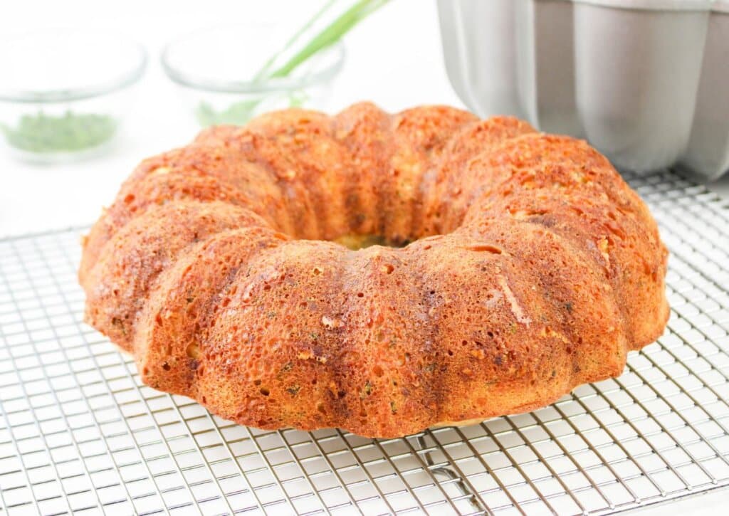 bundt cake being cooled on a wire rack.