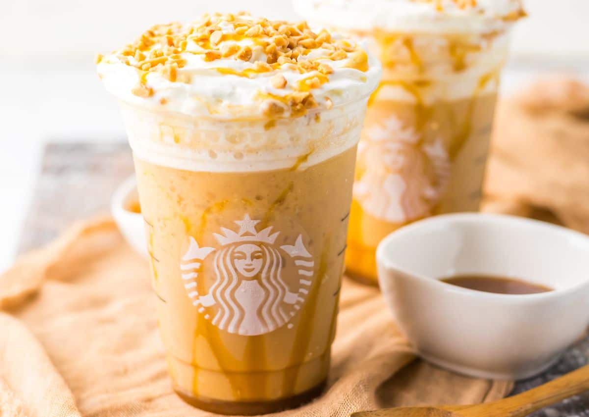 Caramel ribbon crunch Frappuccino in a plastic cup.