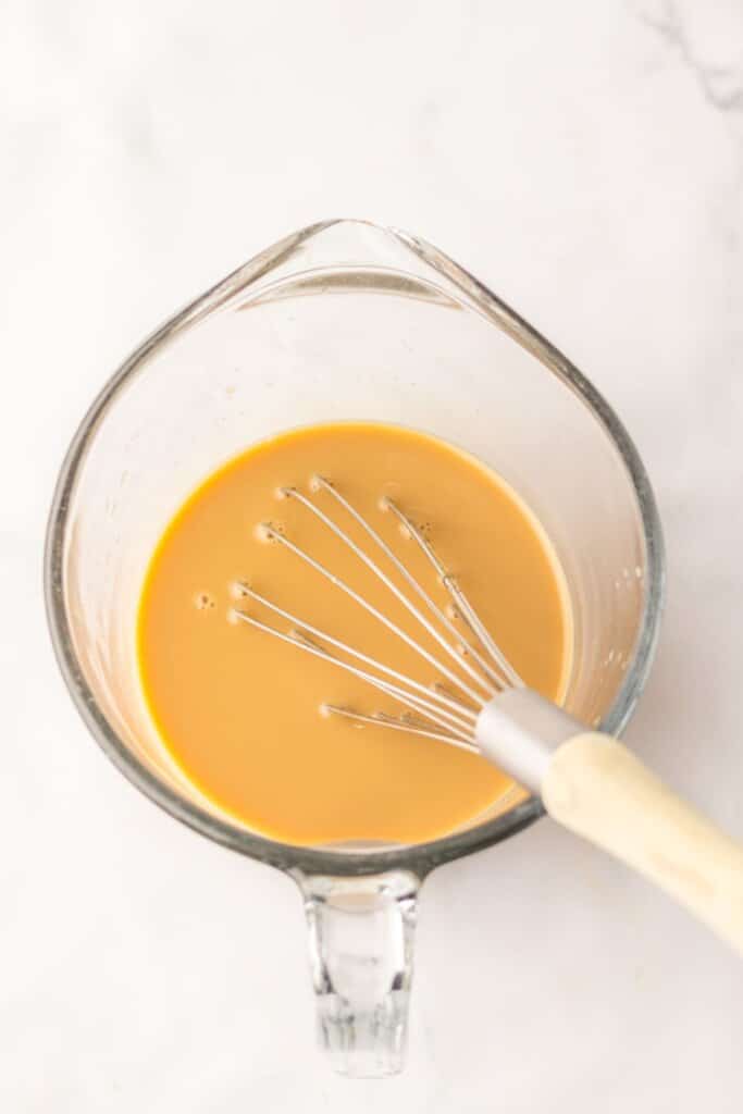 Pudding mixture in a measuring cup.