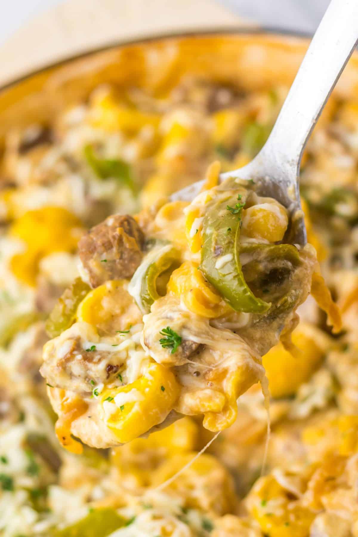 Serving of cheesesteak tortellini on a spoon.