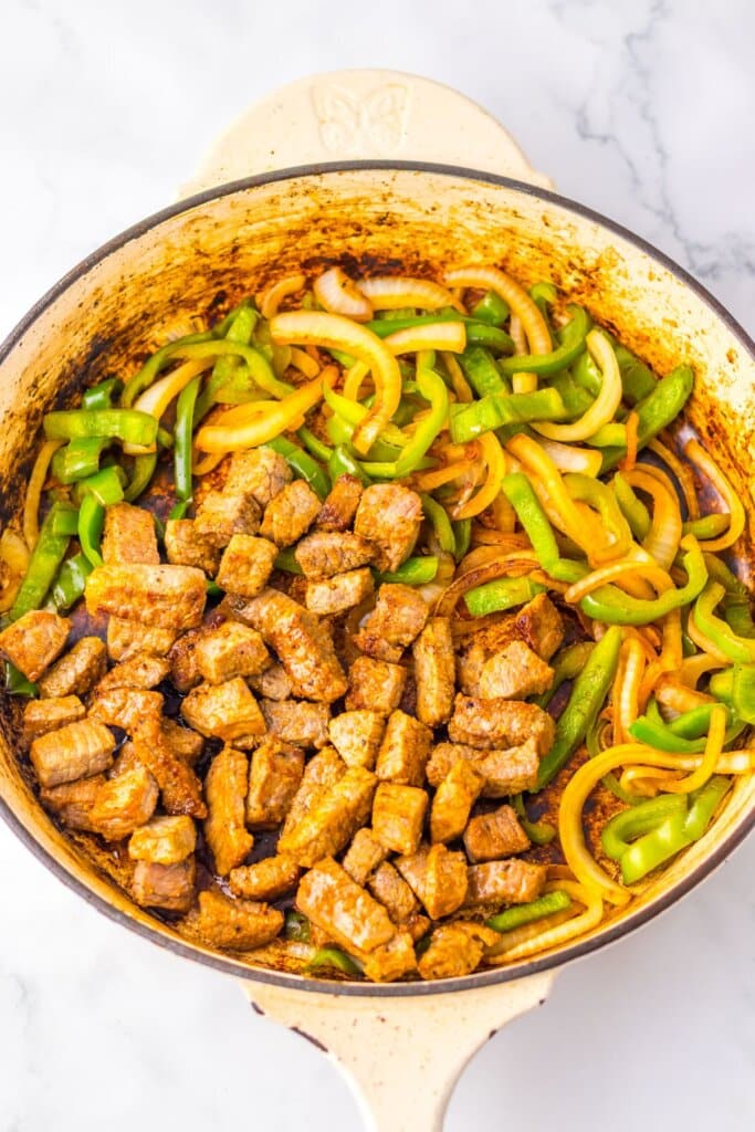 Beef and veggies in a large pot.