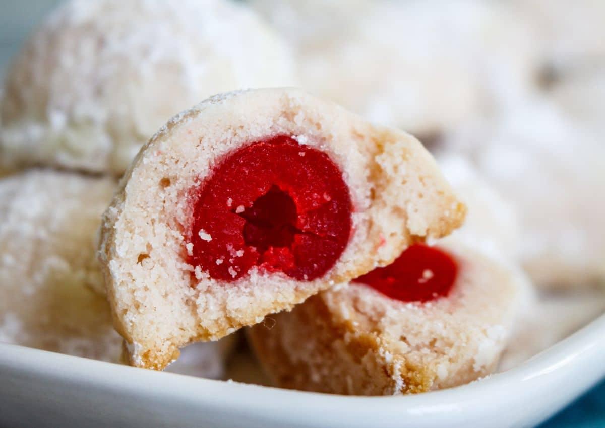 Cherry snowball cookies on a serving platter.