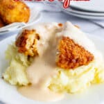 Mashed potatoes on a plate topped with chicken patty.