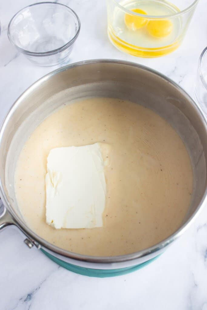 Cream cheese being added to a gravy.