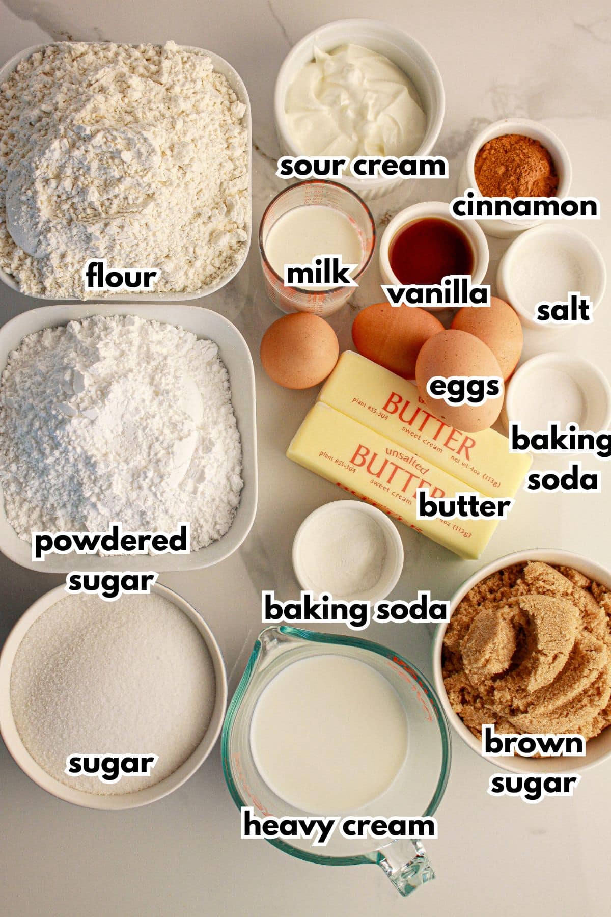 Bowls of ingredients for cinnamon roll bundt cake on a counter labelled with text.