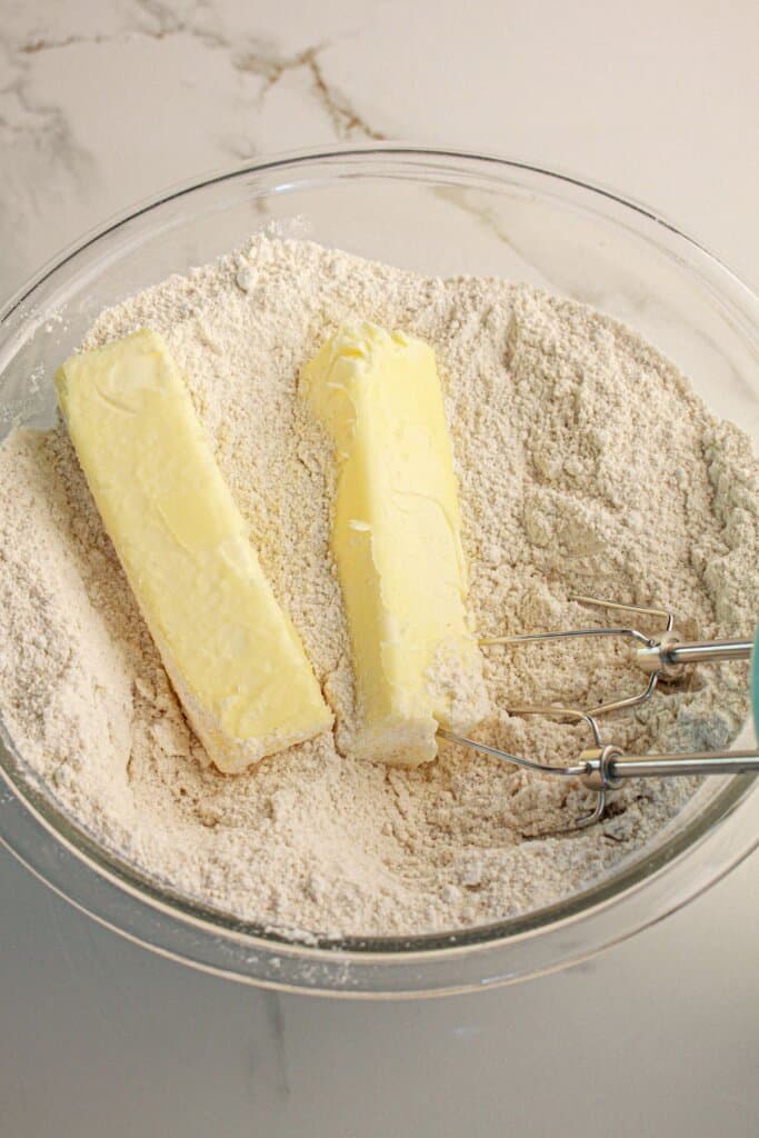 Butter being mixed into dry ingredients.