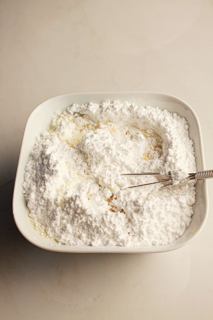 Powdered sugar in a small bowl.