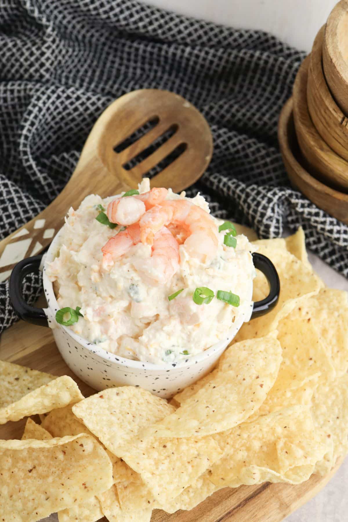 Bowl full of seafood dip surrounded by chips.