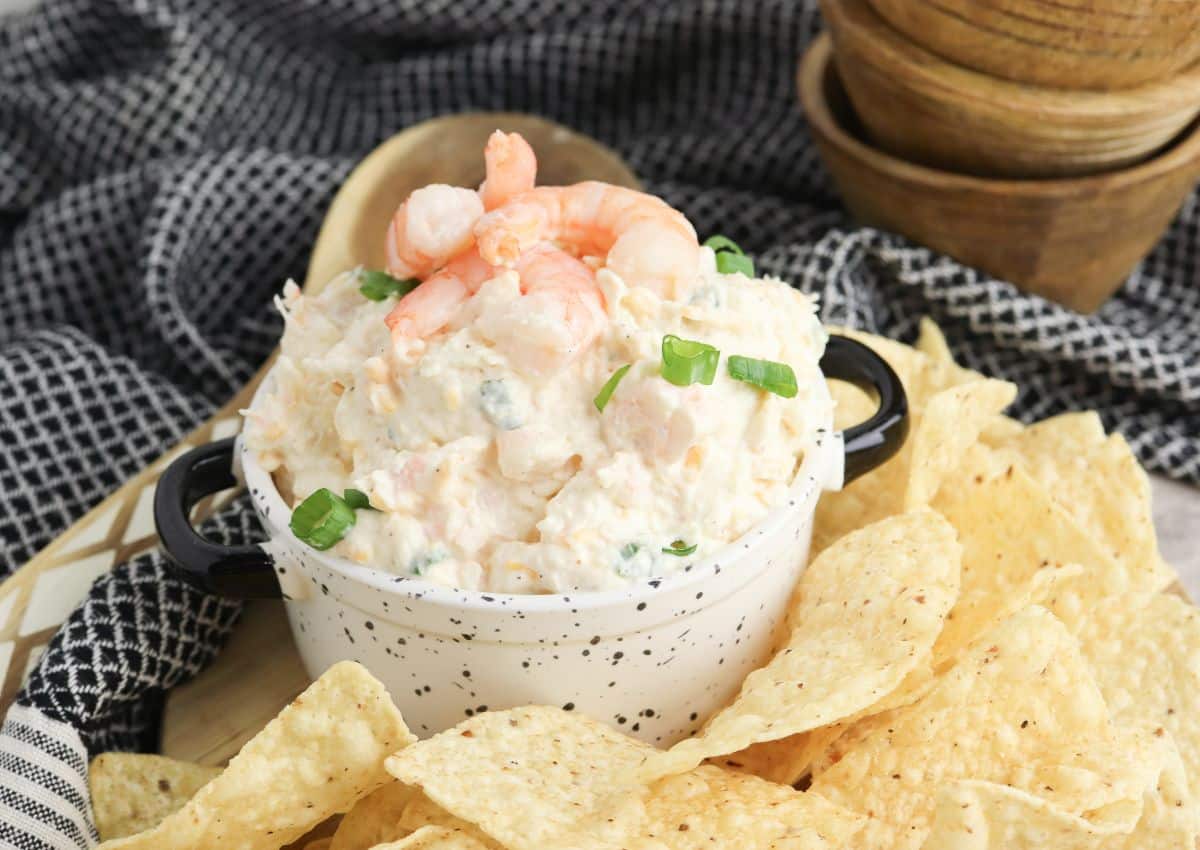 Bowl full of seafood dip surrounded by chips.