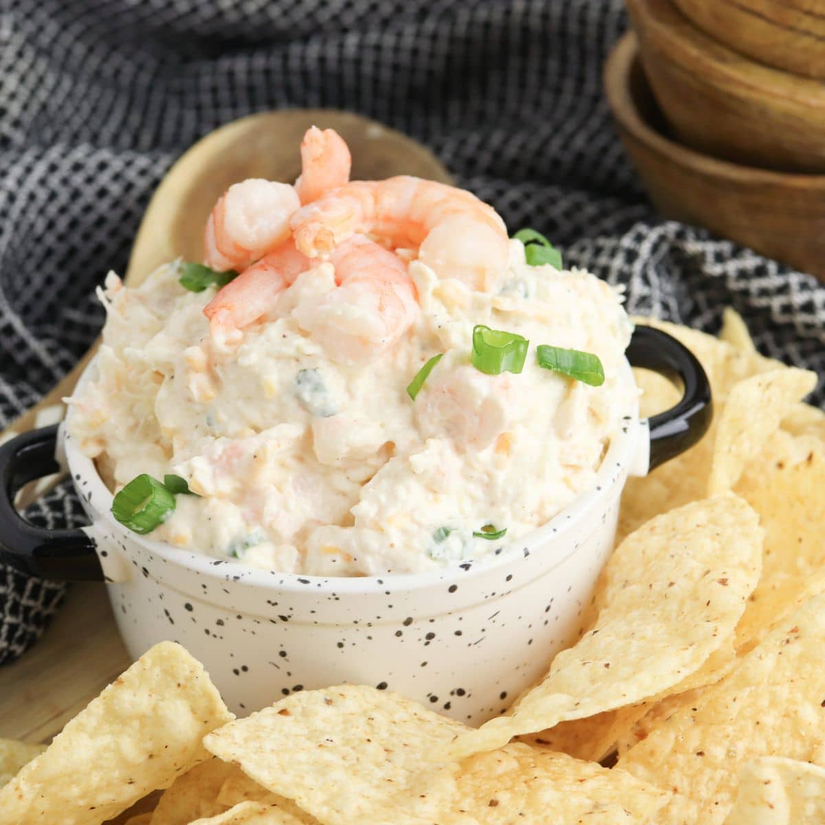 Bowl full of seafood dip surrounded by chips.