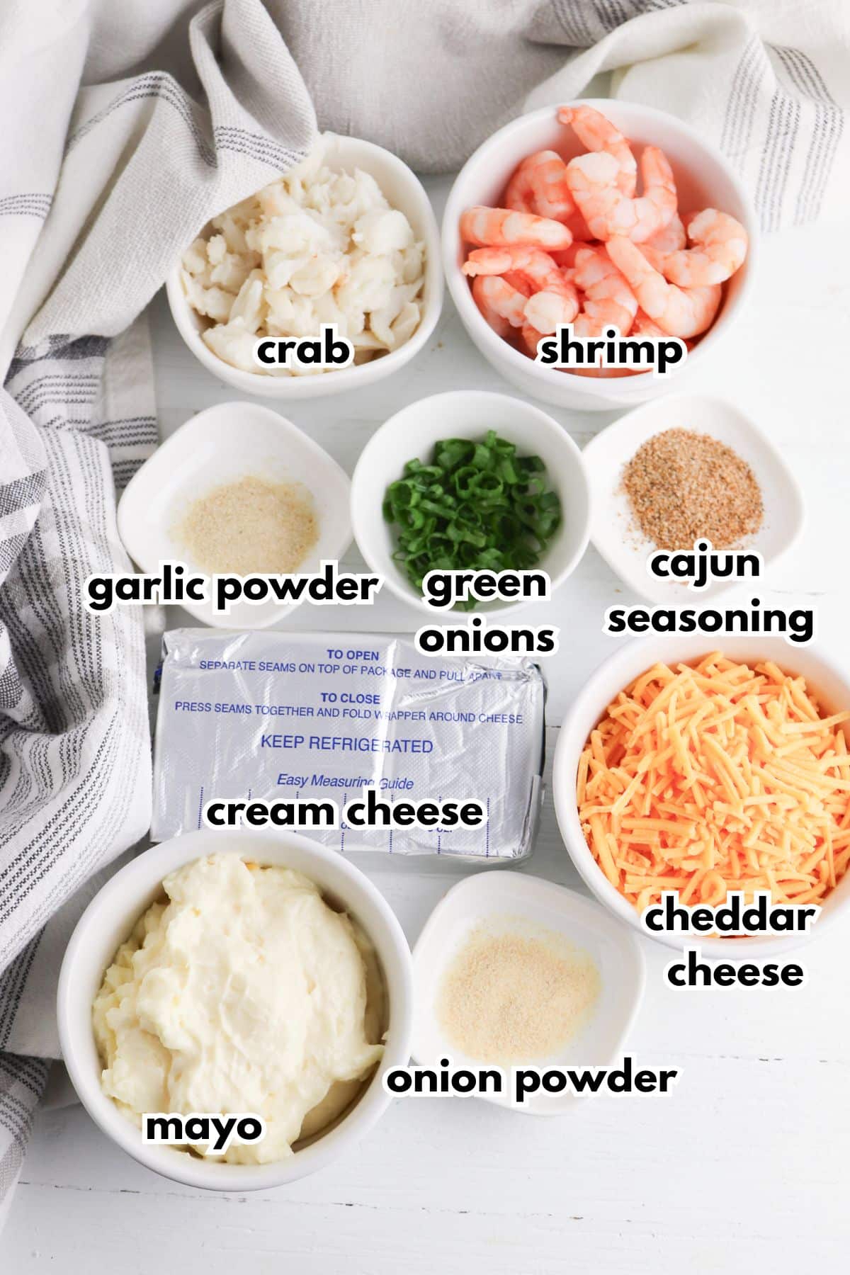 Bowls of ingredients labelled with text on a counter.