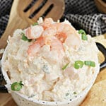 Bowl full of seafood dip surrounded by chips.