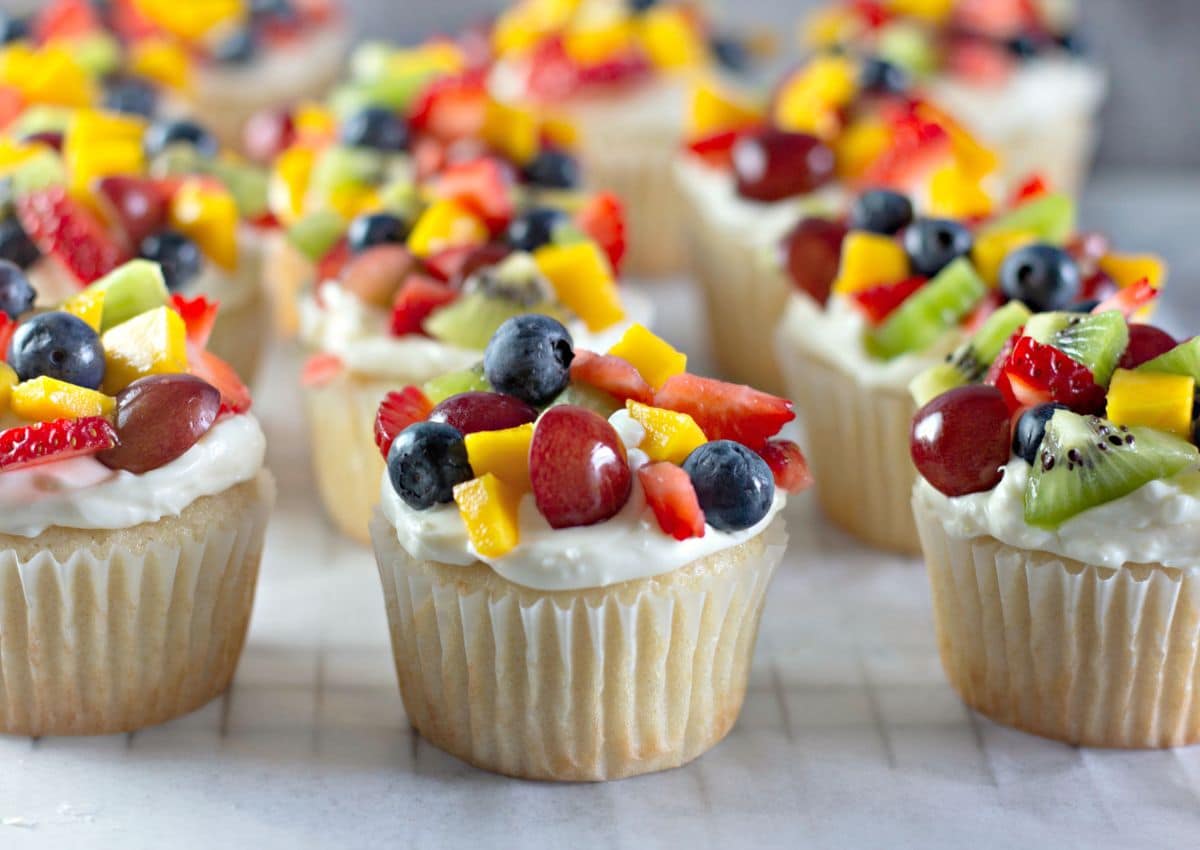 Fruit pizza cupcakes on a counter.