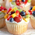 Fruit pizza cupcakes on a counter.
