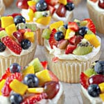 Fruit pizza cupcakes on a counter.