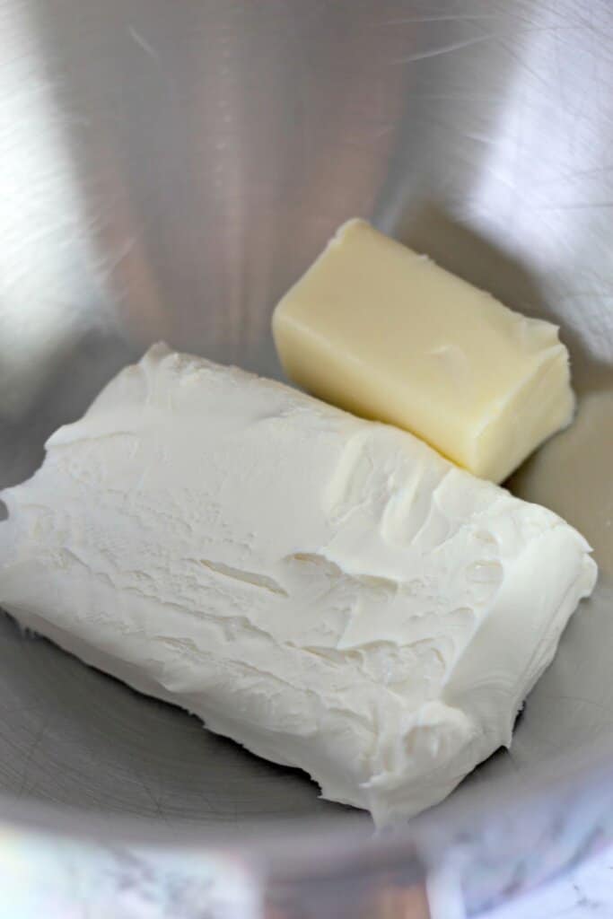 Cream cheese and butter in a mixing bowl.