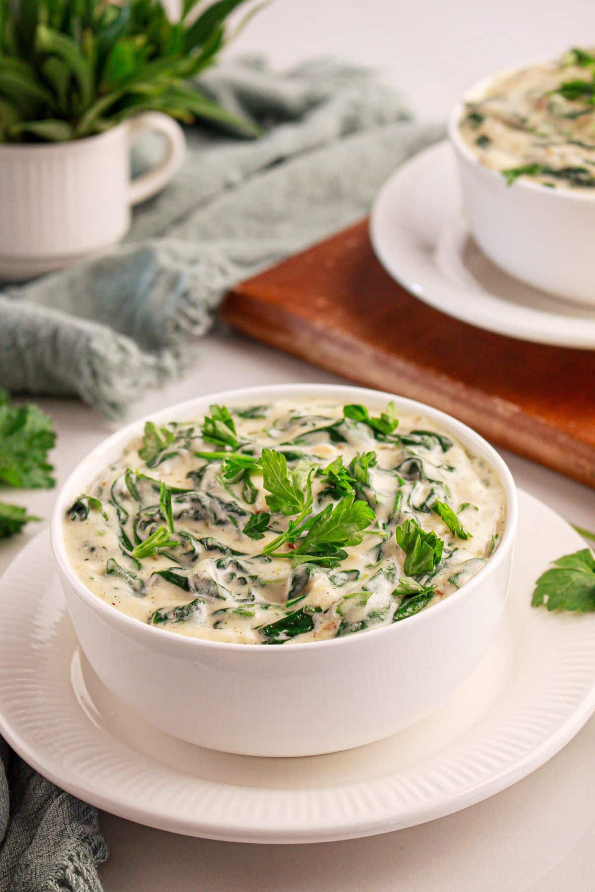 White bowl full of homemade creamed spinach.