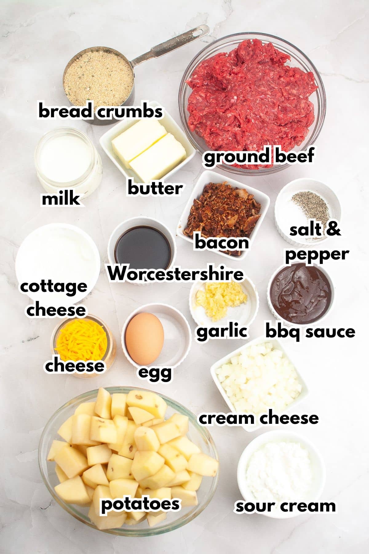Bowls of ingredients labelled with text on a counter.