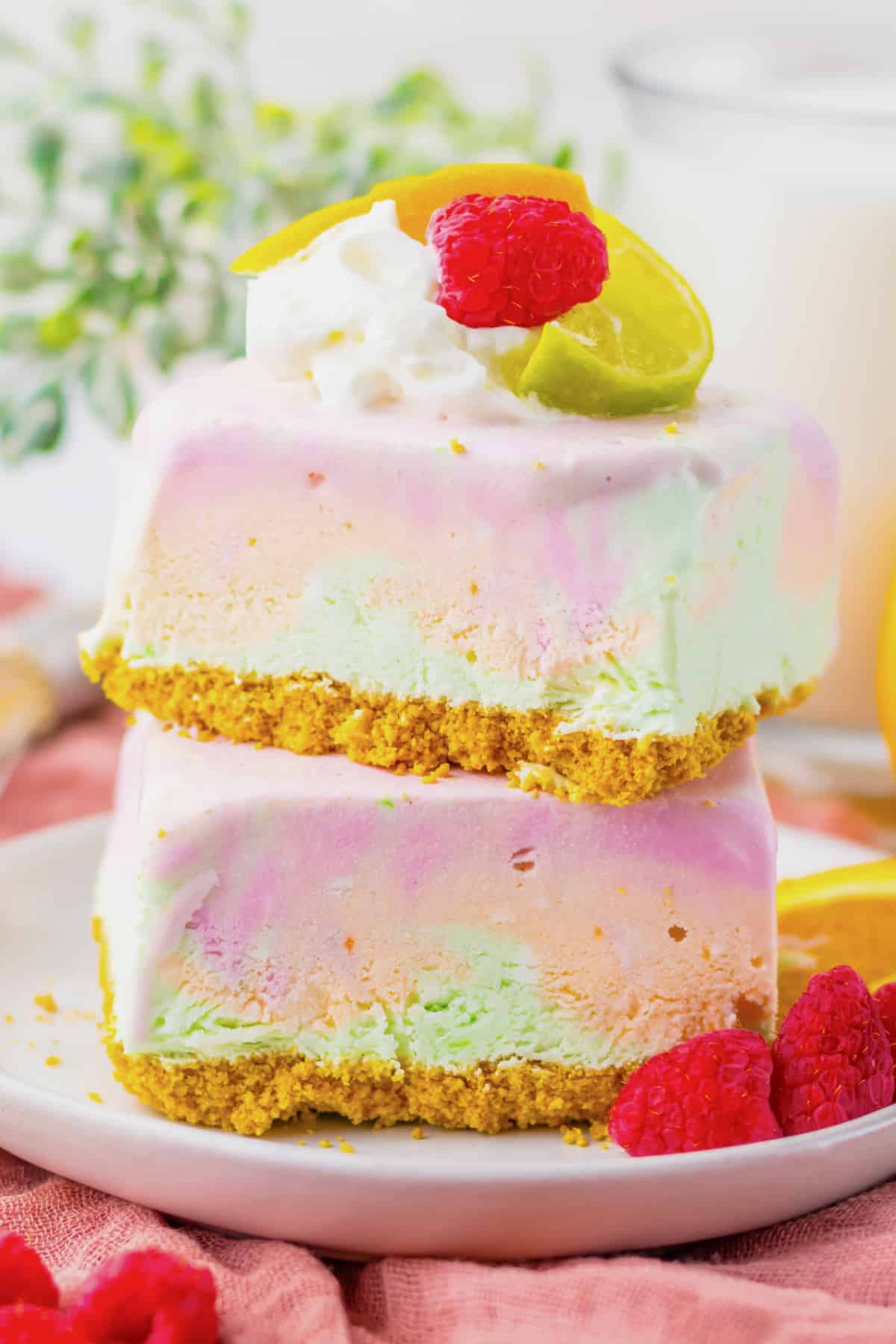 Two rainbow sherbet bars stacked on top of each other.