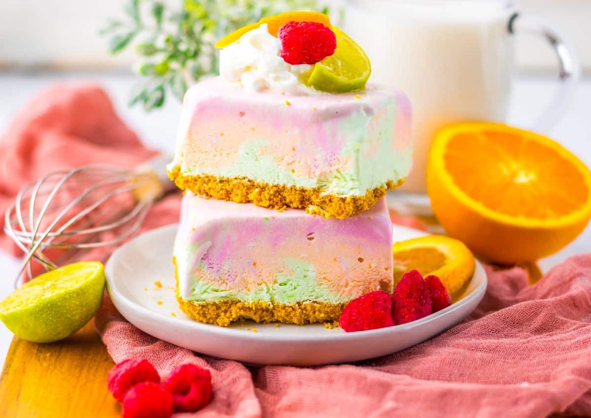 Two rainbow sherbet bars stacked on top of each other.