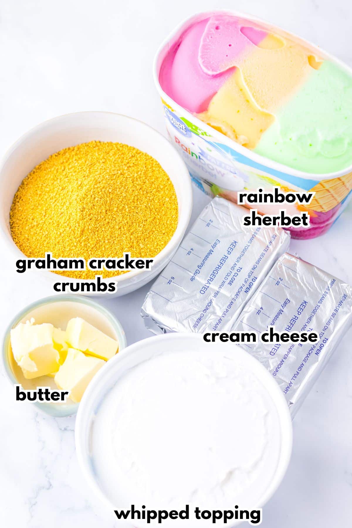 Bowls of ingredients labelled with text on a counter.