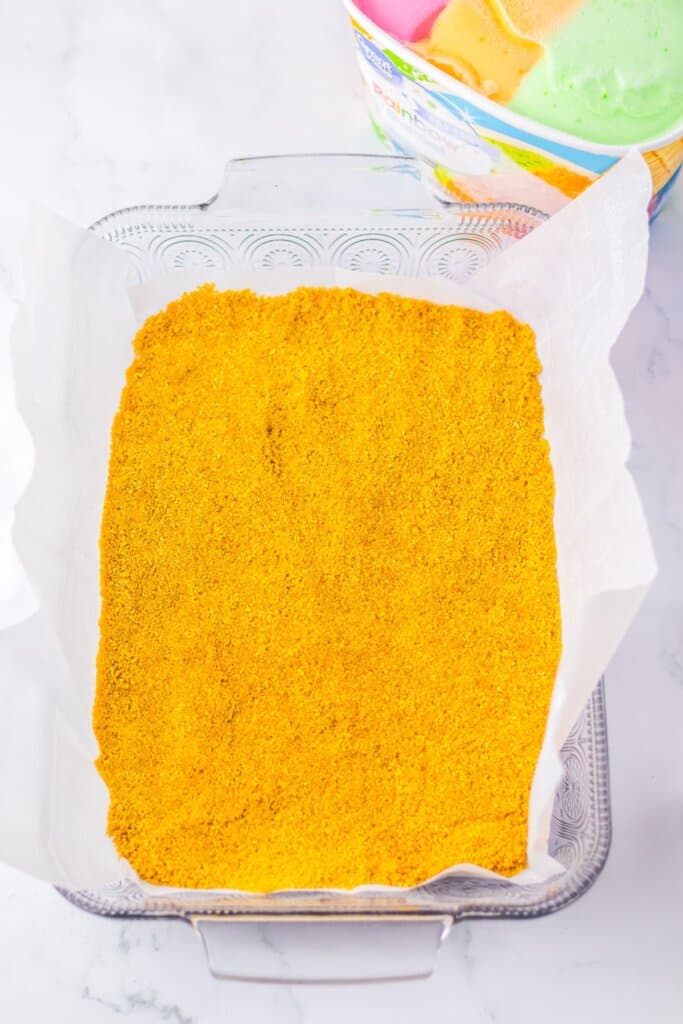 Graham cracker crust pressed into a glass baking dish.