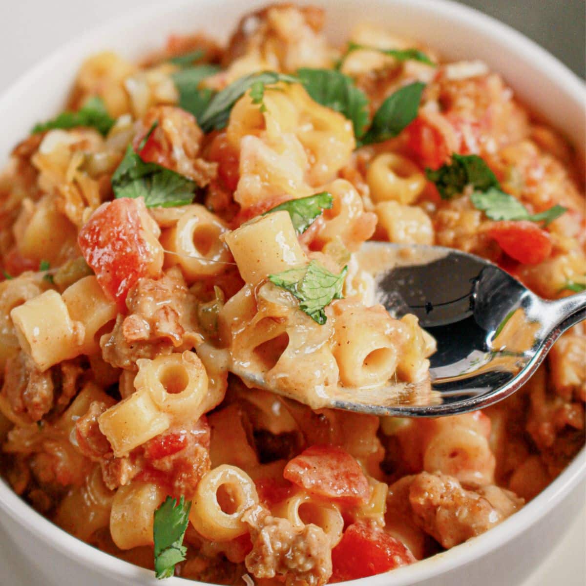 White bowl filled with slow cooker taco pasta.