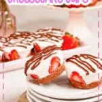 Two strawberry cheesecake cups on a plate.