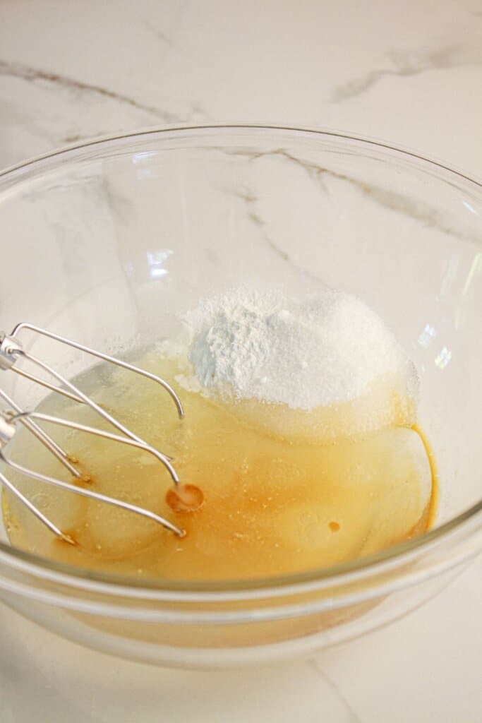 Wet ingredients being in a glass bowl.