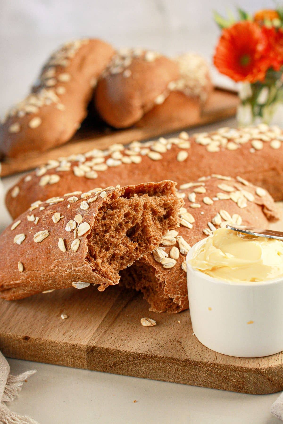 Loaves of bread on a wooden cutting board.