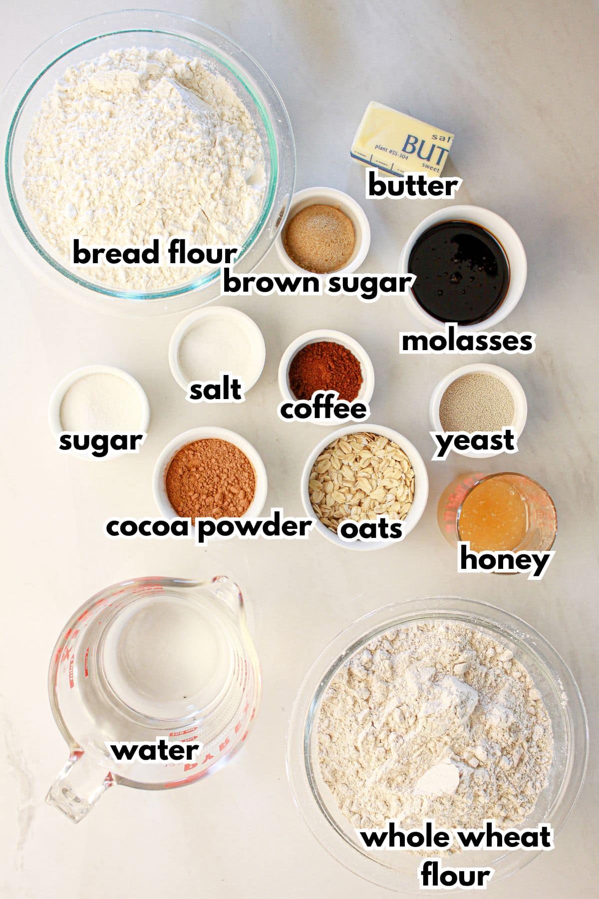 Bowls of ingredients labelled with text on a counter.