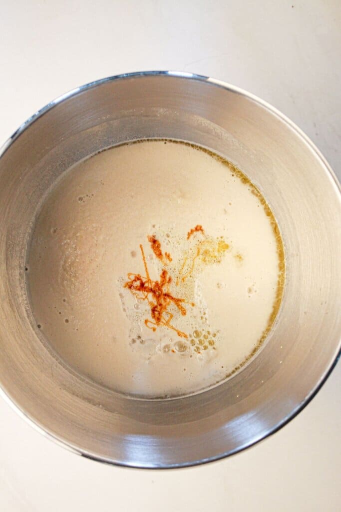 Wet ingredients in a stainless steel mixing bowl.