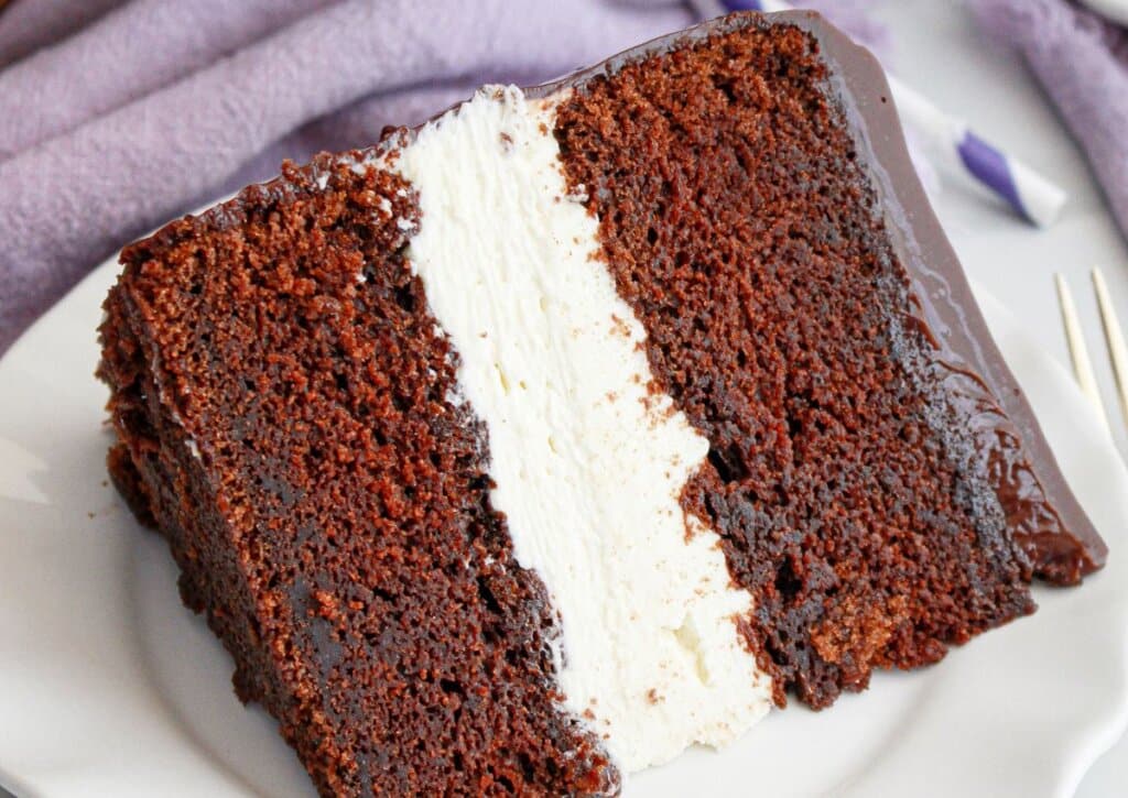 Slice of ding dong cake on a plate.