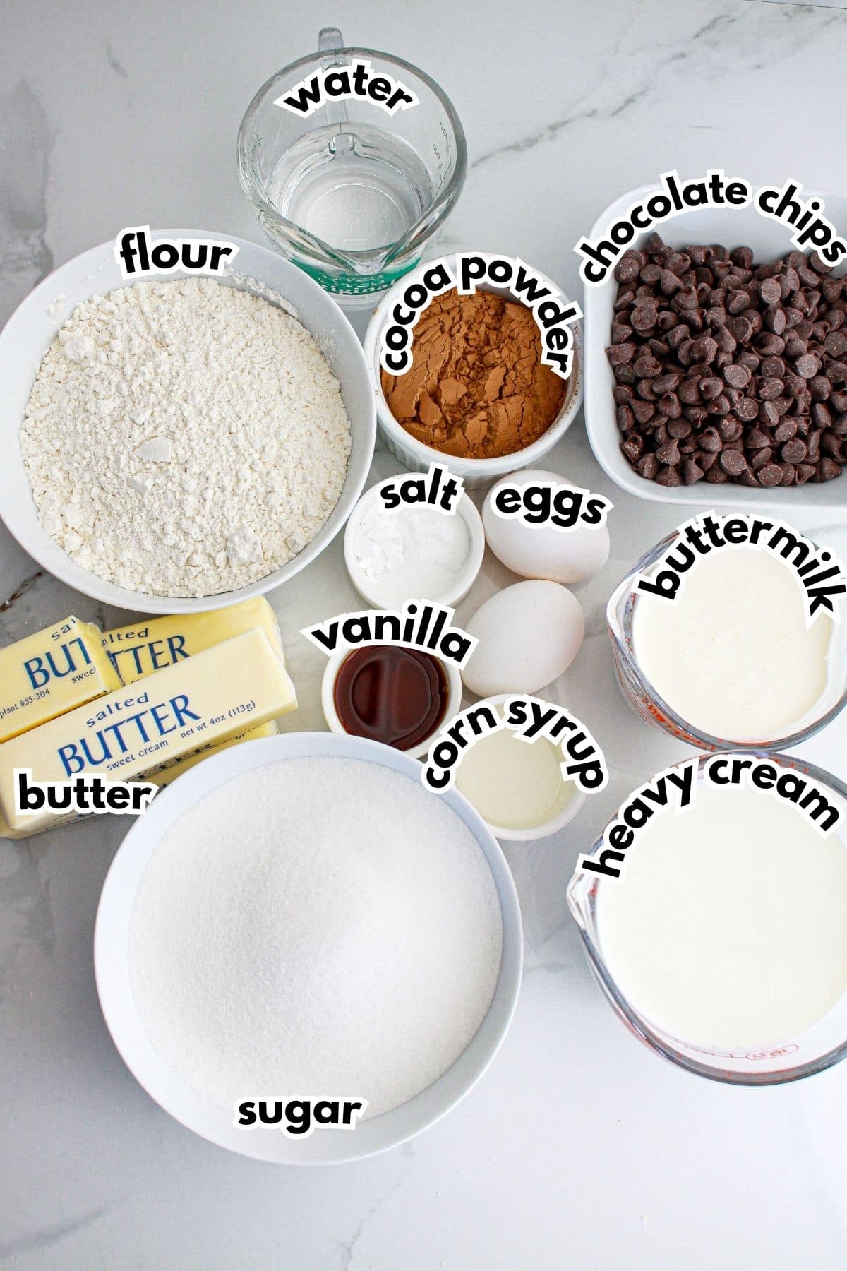 Bowls of ingredients labelled with text on a counter.