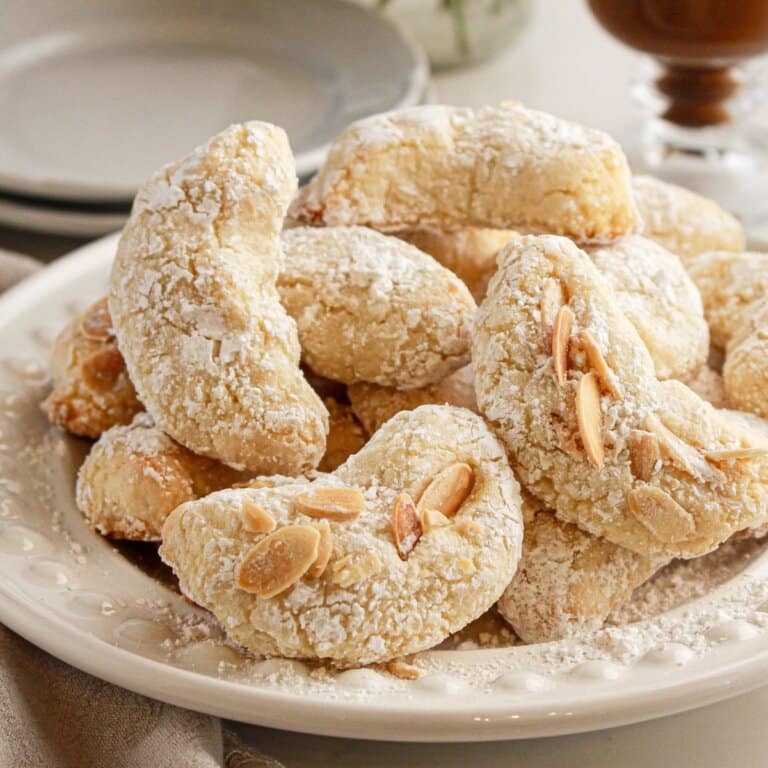 Italian amaretti cookies on a white plate.