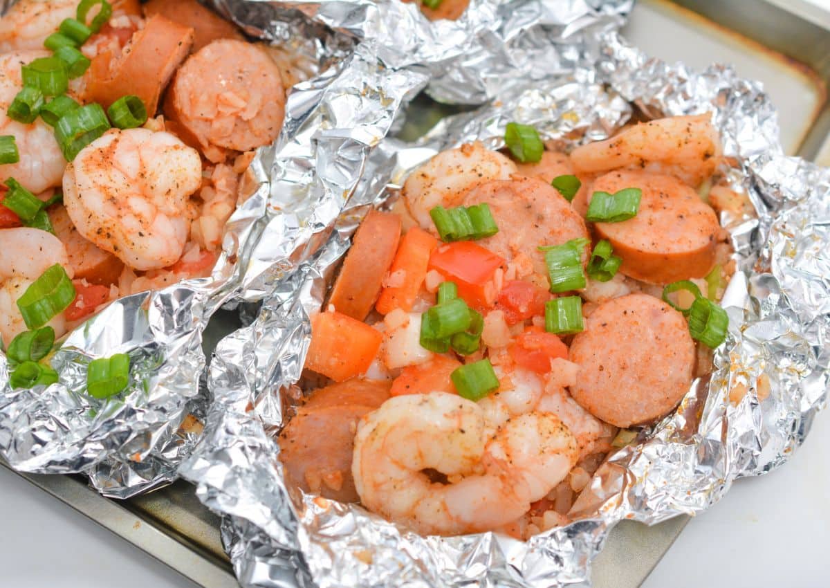 Foil packets on a baking sheet.