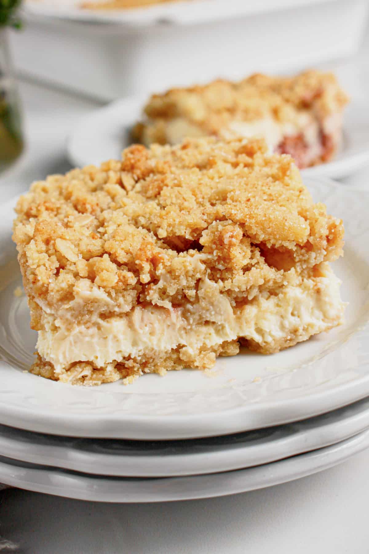 Slice of lemon cheesecake crumb bars on a plate.