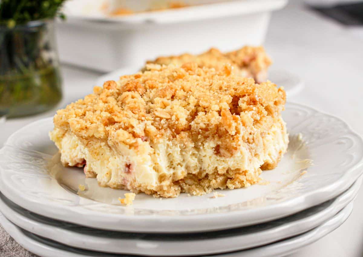 Slice of lemon cheesecake crumb bars on a plate.