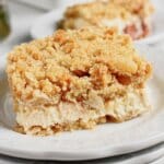 Slice of lemon cheesecake crumb bars on a plate.